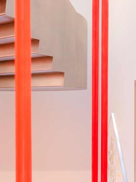 Exhibition view with red vertical bars and staircase at Heidi Horten Collection Vienna.