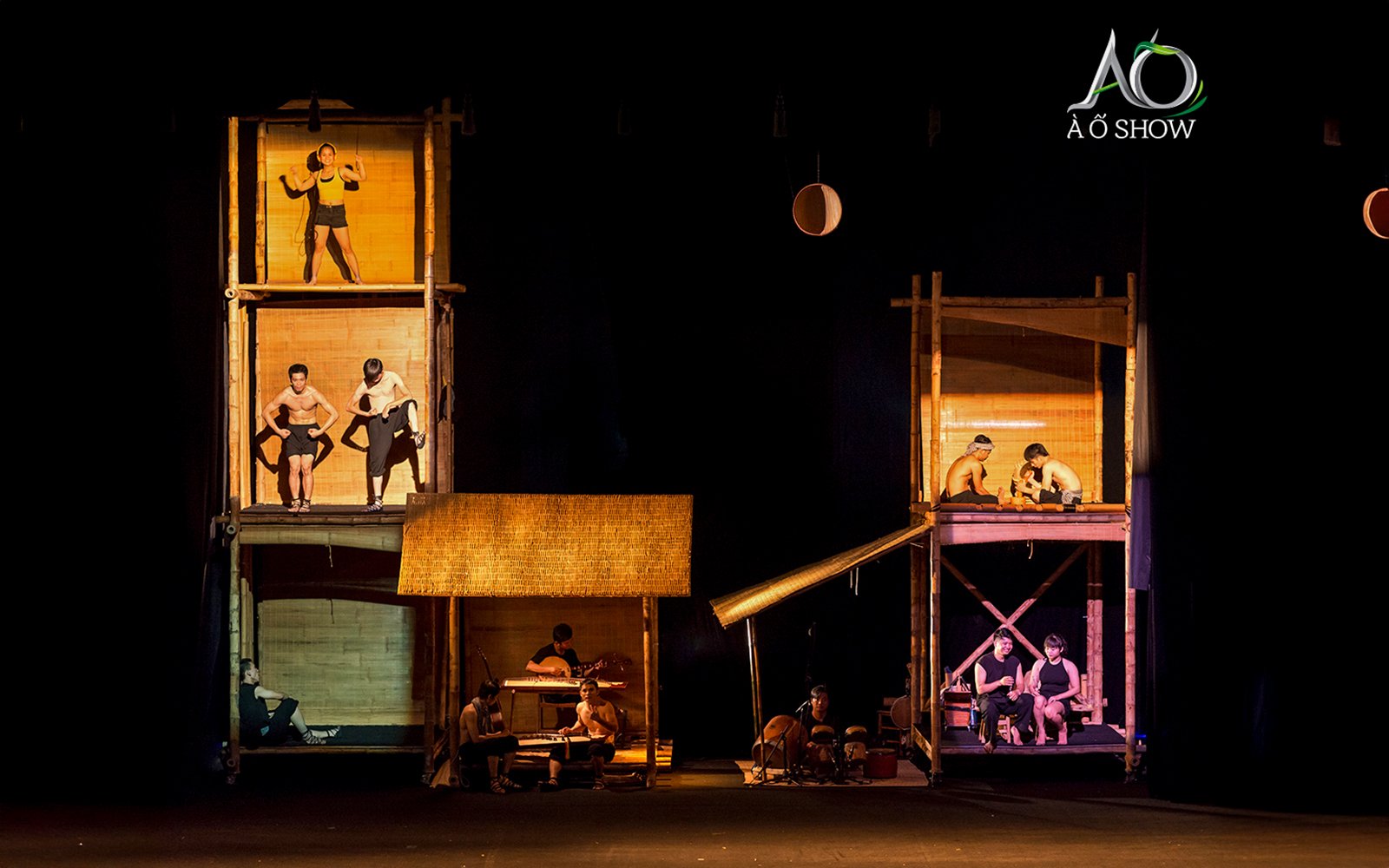 Performers in bamboo structures at AO Show tableaux.
