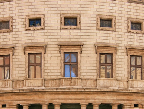 Palazzo Massimo facade with columns and arched windows in Rome, Italy.
