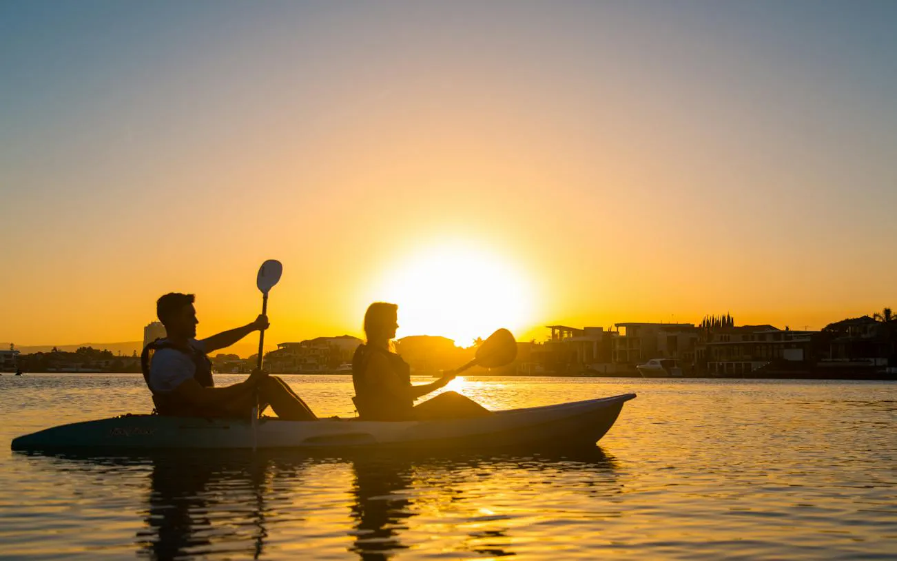 Kayakers paddling at sunset on Surfers Paradise Guided Kayak Tour, Gold Coast.