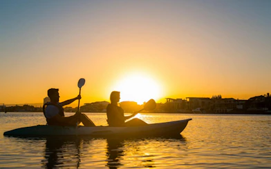 Kayakers paddling at sunset on Surfers Paradise Guided Kayak Tour, Gold Coast.