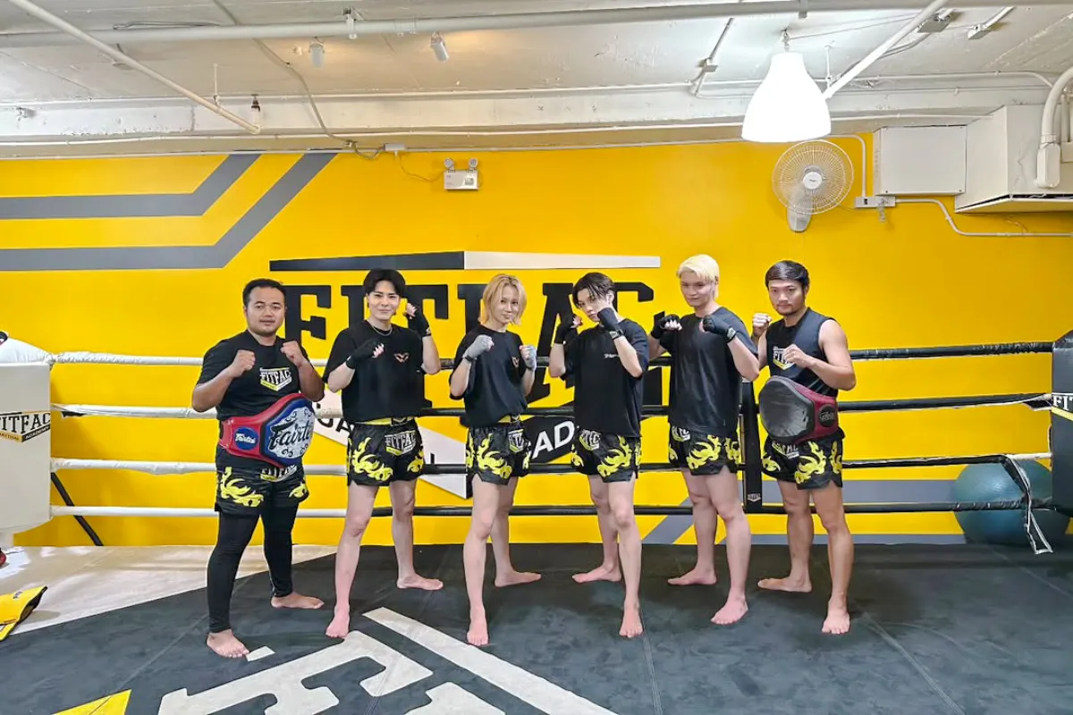 Muay Thai class participants in Bangkok gym with free shorts and pickup.