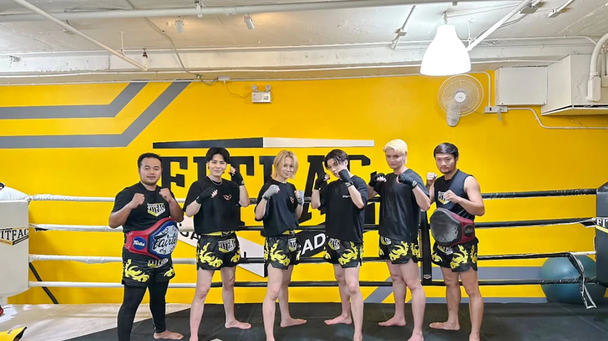 Muay Thai class participants in Bangkok gym with free shorts and pickup.