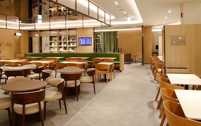 Plaza Premium Lounge seating area with tables and chairs in South Korea.