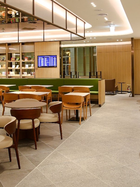 Plaza Premium Lounge seating area with tables and chairs in South Korea.