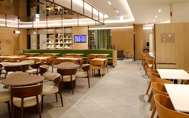 Plaza Premium Lounge seating area with tables and chairs in South Korea.