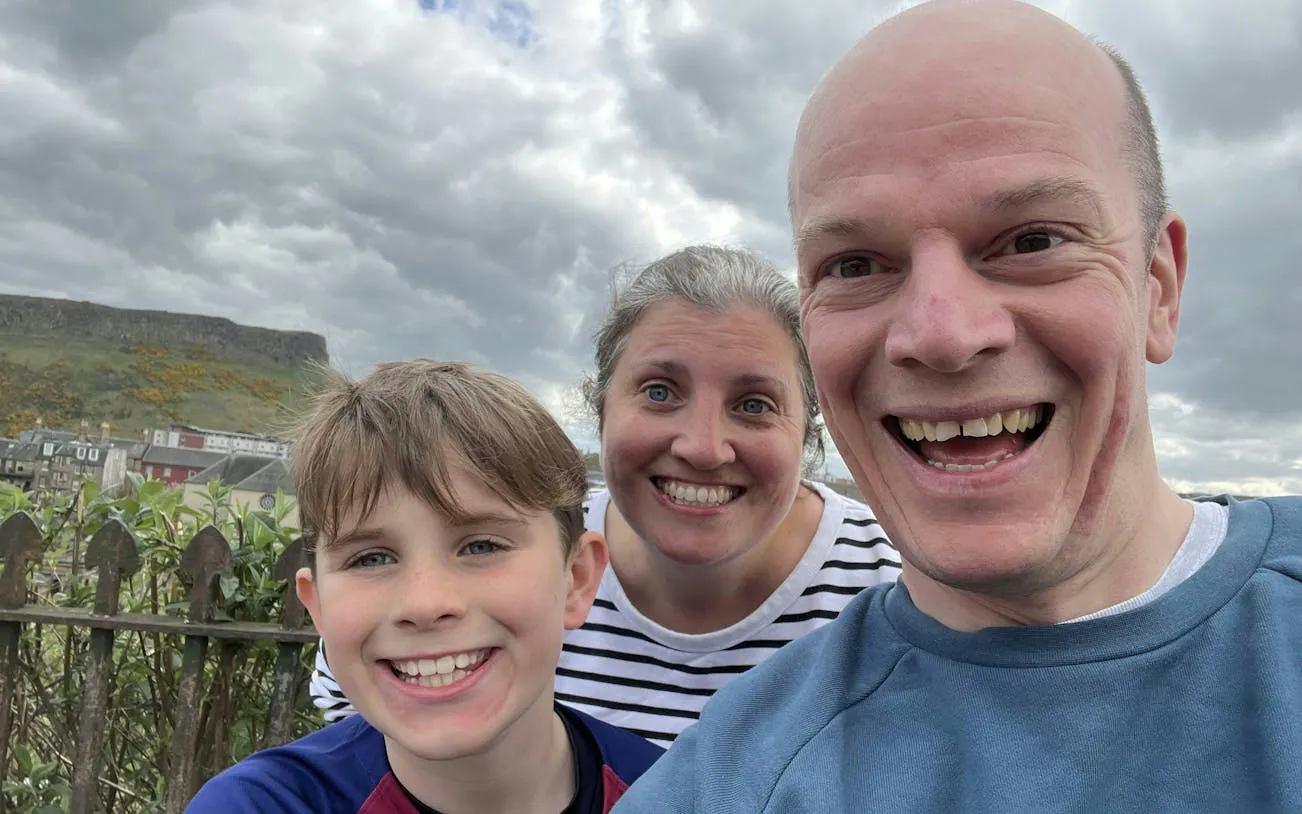 Family enjoying The Edinburgh Enigma city exploration game with Arthur's Seat in the background.