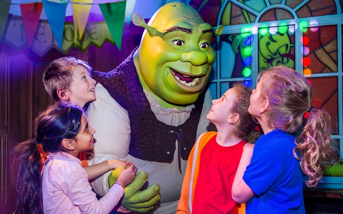 Children interacting with Shrek at Shrek’s Adventure! London.