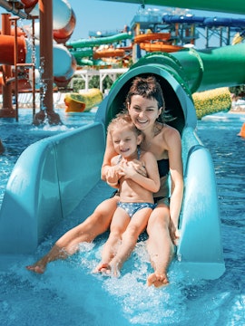 Mother and daughter on water slide at Adventure Cove Waterpark.