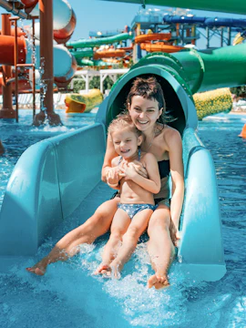 Mother and daughter on water slide at Adventure Cove Waterpark.