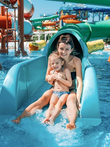 Mother and daughter on water slide at Adventure Cove Waterpark.