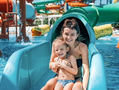 Mother and daughter on water slide at Adventure Cove Waterpark.