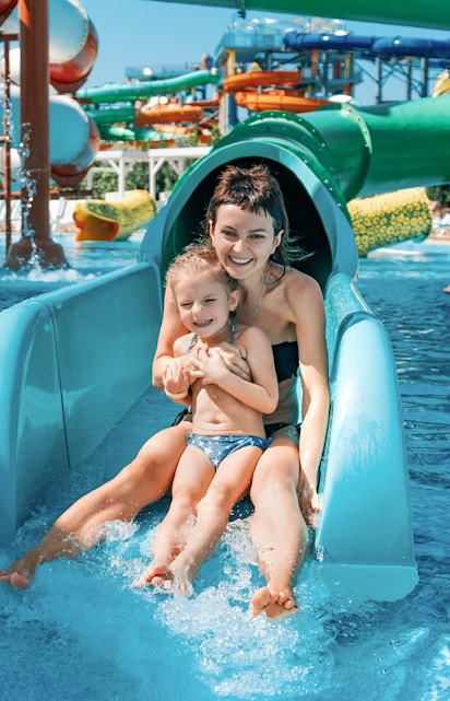 Mother and daughter on water slide at Adventure Cove Waterpark.