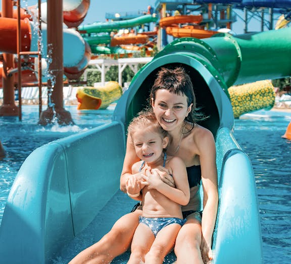 Mother and daughter on water slide at Adventure Cove Waterpark.