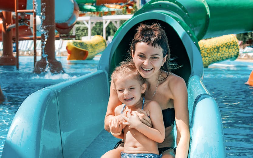 Mother and daughter on water slide at Adventure Cove Waterpark.