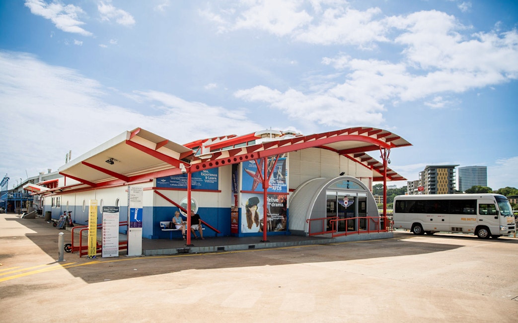 Royal Flying Doctor Service building in Alice Springs with shuttle bus nearby.