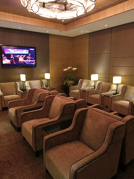 Plaza Premium Lounge seating area with armchairs and lamps, Kuala Lumpur airport.