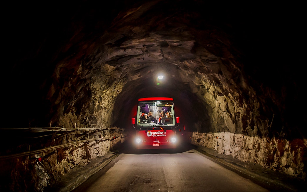 Bus traveling through Homer Tunnel towards Milford Sound.