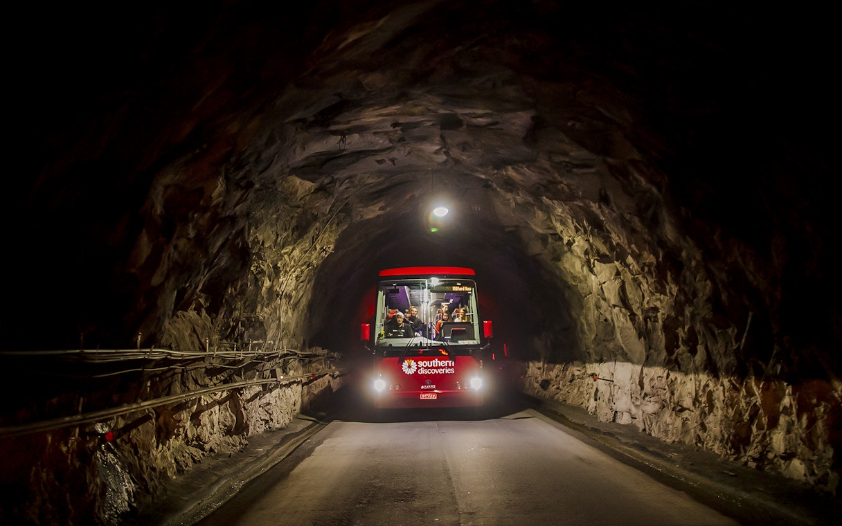 Bus traveling through Homer Tunnel towards Milford Sound.