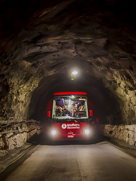 Bus traveling through Homer Tunnel towards Milford Sound.