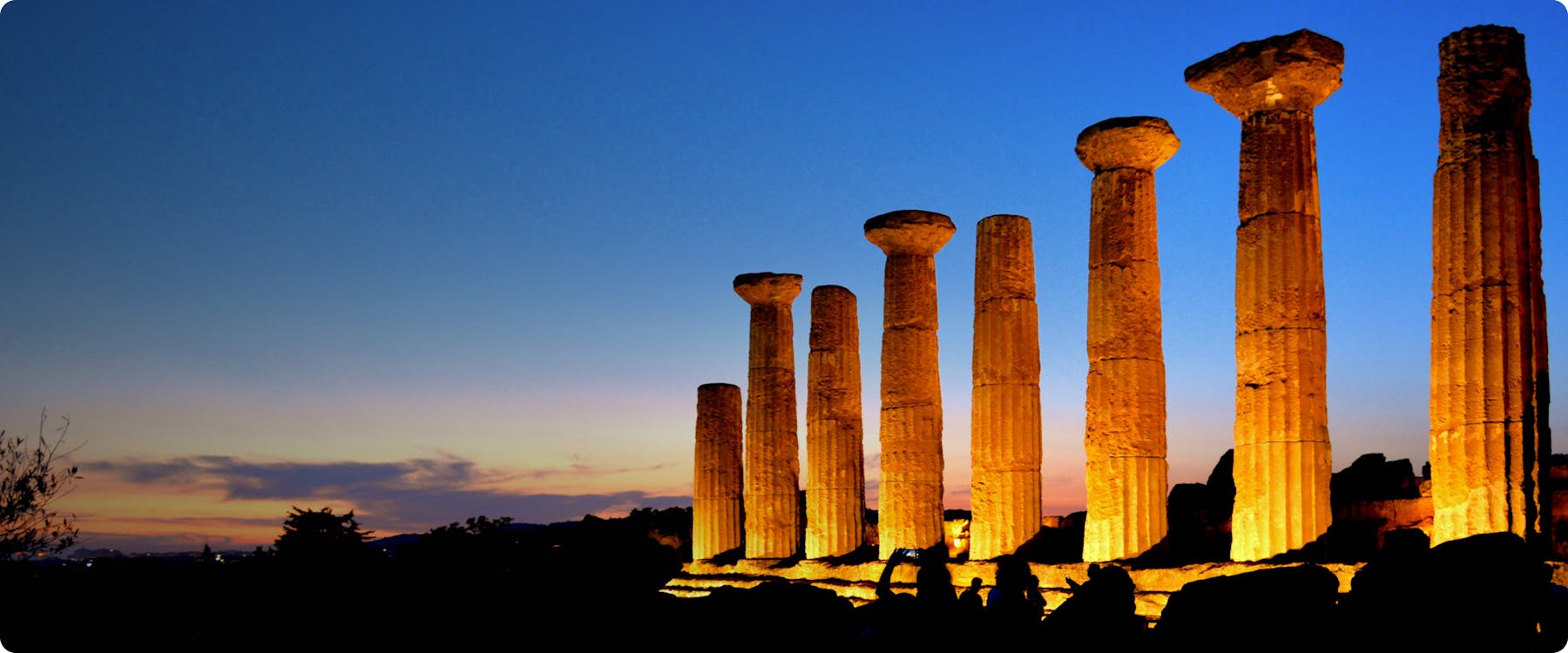 Ancient Greek temple columns at sunset in Agrigento, Sicily.