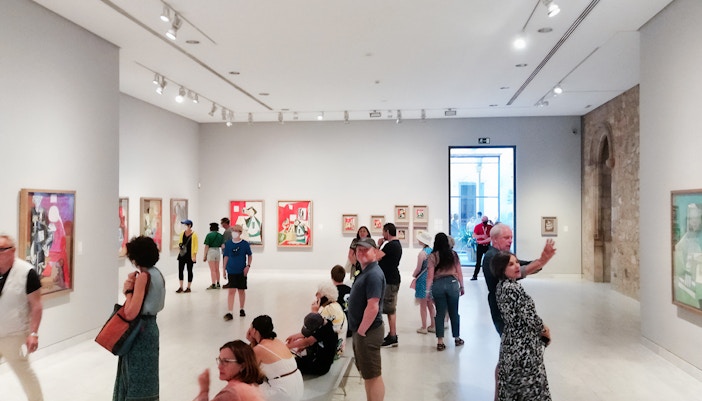 Visitors exploring Picasso Museum Barcelona exhibits.