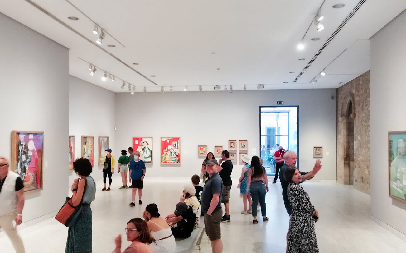 Visitors viewing Picasso paintings at the Picasso Museum in Barcelona.