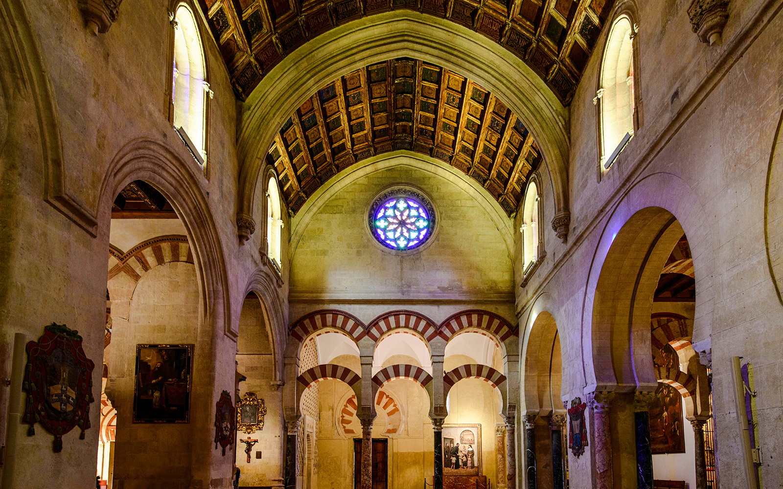 Cathedral nave with arches and stained glass in Cordoba Mosque.