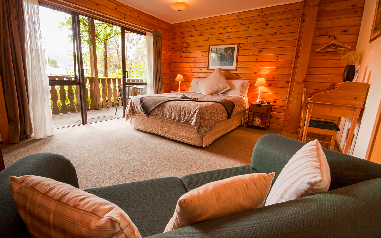 Milford Sound Lodge nestled in lush New Zealand fjordland with mountain views.
