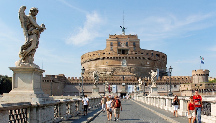 Guided tour group at Castel Sant'Angelo, Rome, Italy, viewing historic architecture.