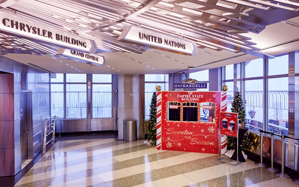 Empire State Building interior with Christmas decorations and Ghirardelli display.