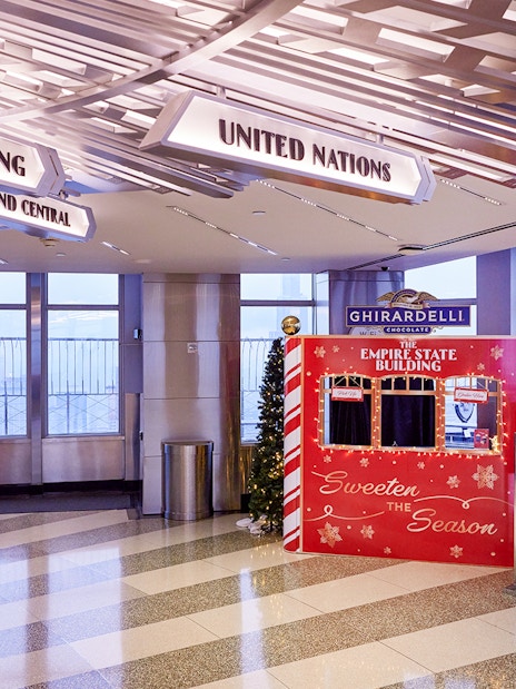 Empire State Building interior with Christmas decorations and Ghirardelli display.