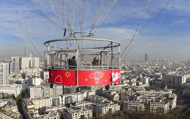 Passengers inside Generali Balloon over Paris skyline.