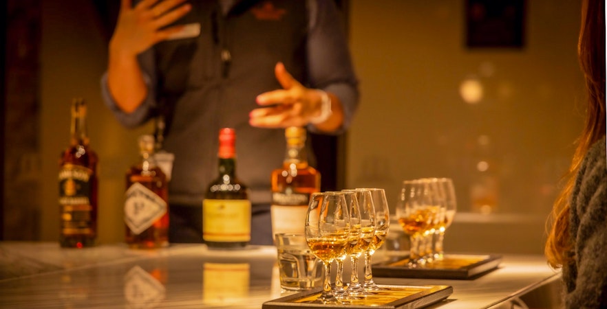 Midleton Distillery whiskey tasting experience with Jameson barrels and glasses.
