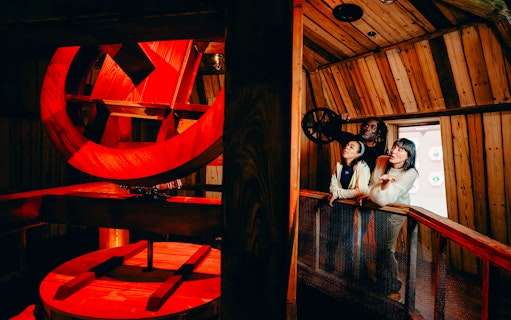 Guests observing windmill interior on Highlights of Holland tour.
