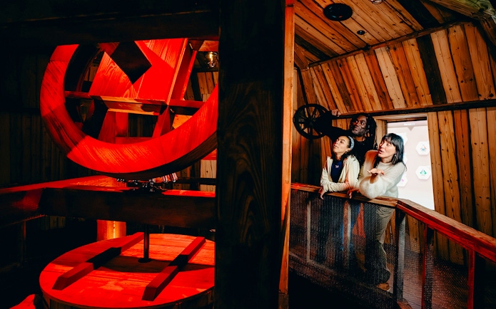Guests observing windmill interior on Highlights of Holland tour.