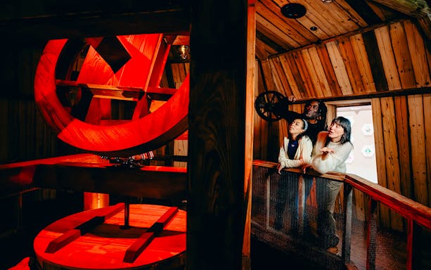 Guests observing windmill interior on Highlights of Holland tour.