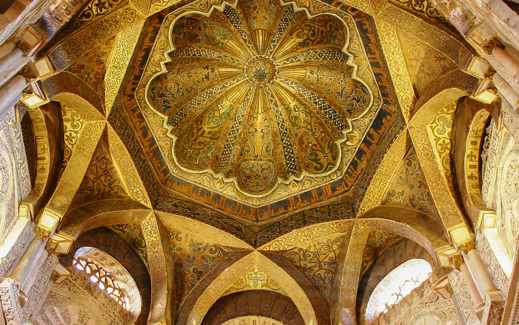 Ceiling of the Mosque-Cathedral of Córdoba with intricate gold and geometric designs.