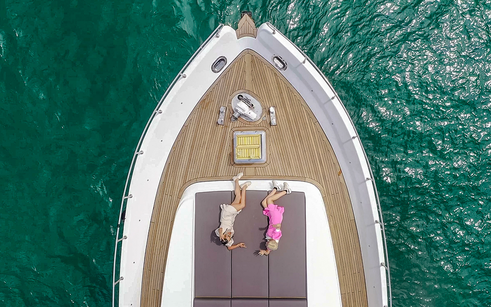 Two women relaxing on a yacht deck during Bosphorus Private Luxury Yacht Cruise.