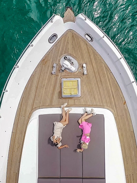 Two women relaxing on a yacht deck during Bosphorus Private Luxury Yacht Cruise.