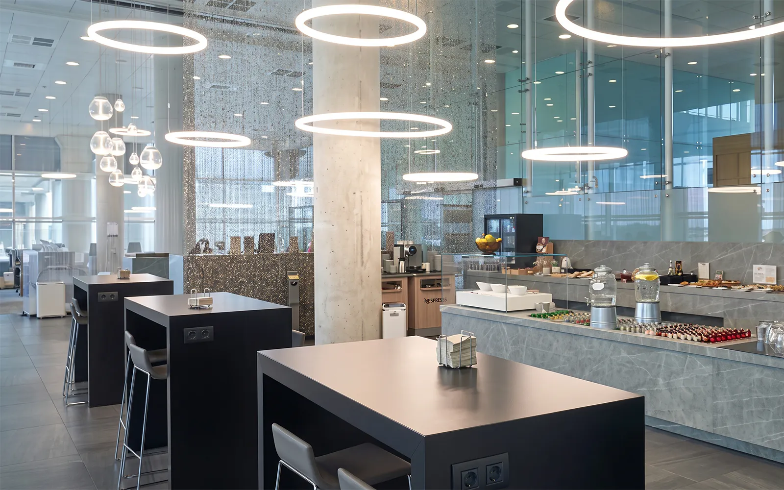 Colomer VIP Lounge seating and refreshment area at Barcelona El Prat Airport (T1).