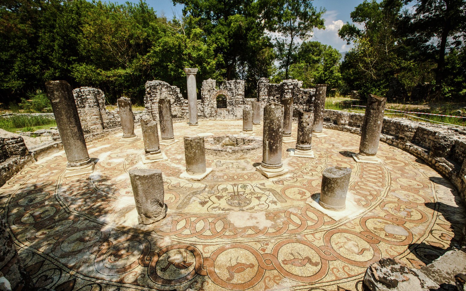 Ancient circular mosaic and columns at Butrint ruins, Albania.