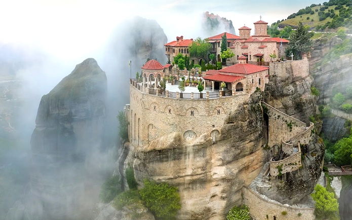 Varlaam Monastery perched on a misty cliff in Meteora, Greece.