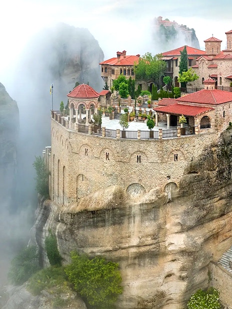 Varlaam Monastery perched on a misty cliff in Meteora, Greece.