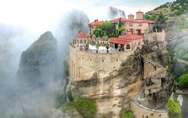 Varlaam Monastery perched on a misty cliff in Meteora, Greece.