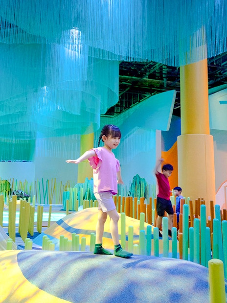 Children exploring colorful indoor play area at Grassland Camo Curiosity Cove.