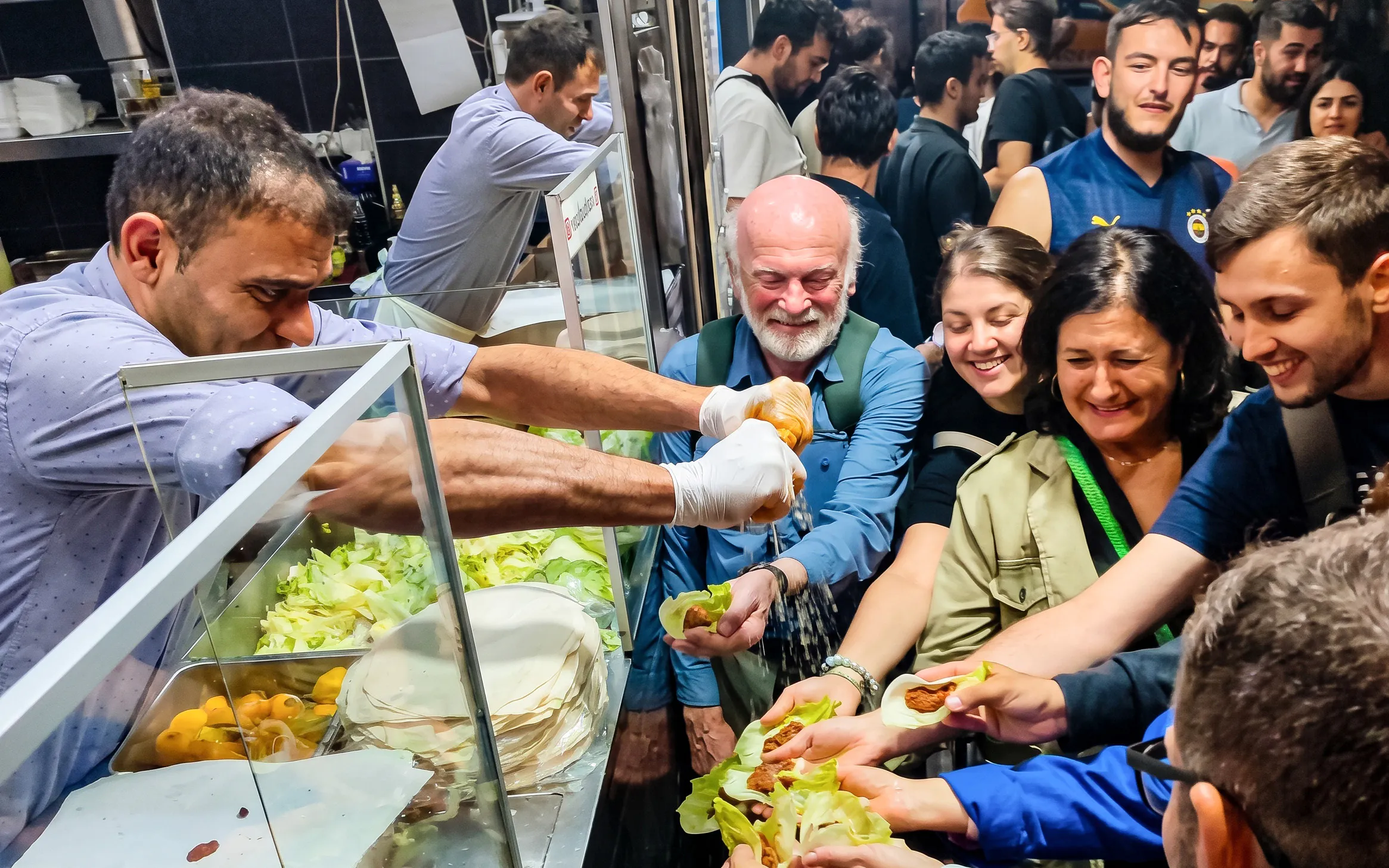 Guests receiving Turkish food at a night event in Istanbul.
