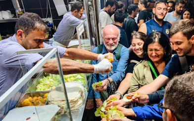 Guests receiving Turkish food at a night event in Istanbul.