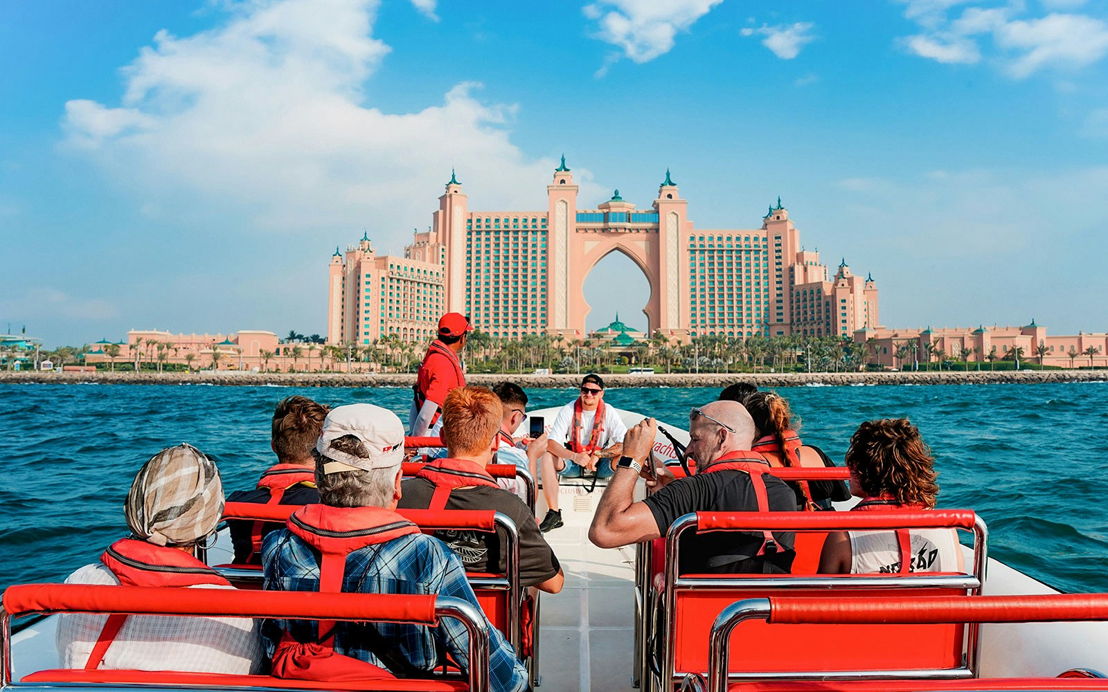 Speedboat cruising past Dubai Marina with views of Atlantis, Palm Jumeirah, and Burj Al Arab.