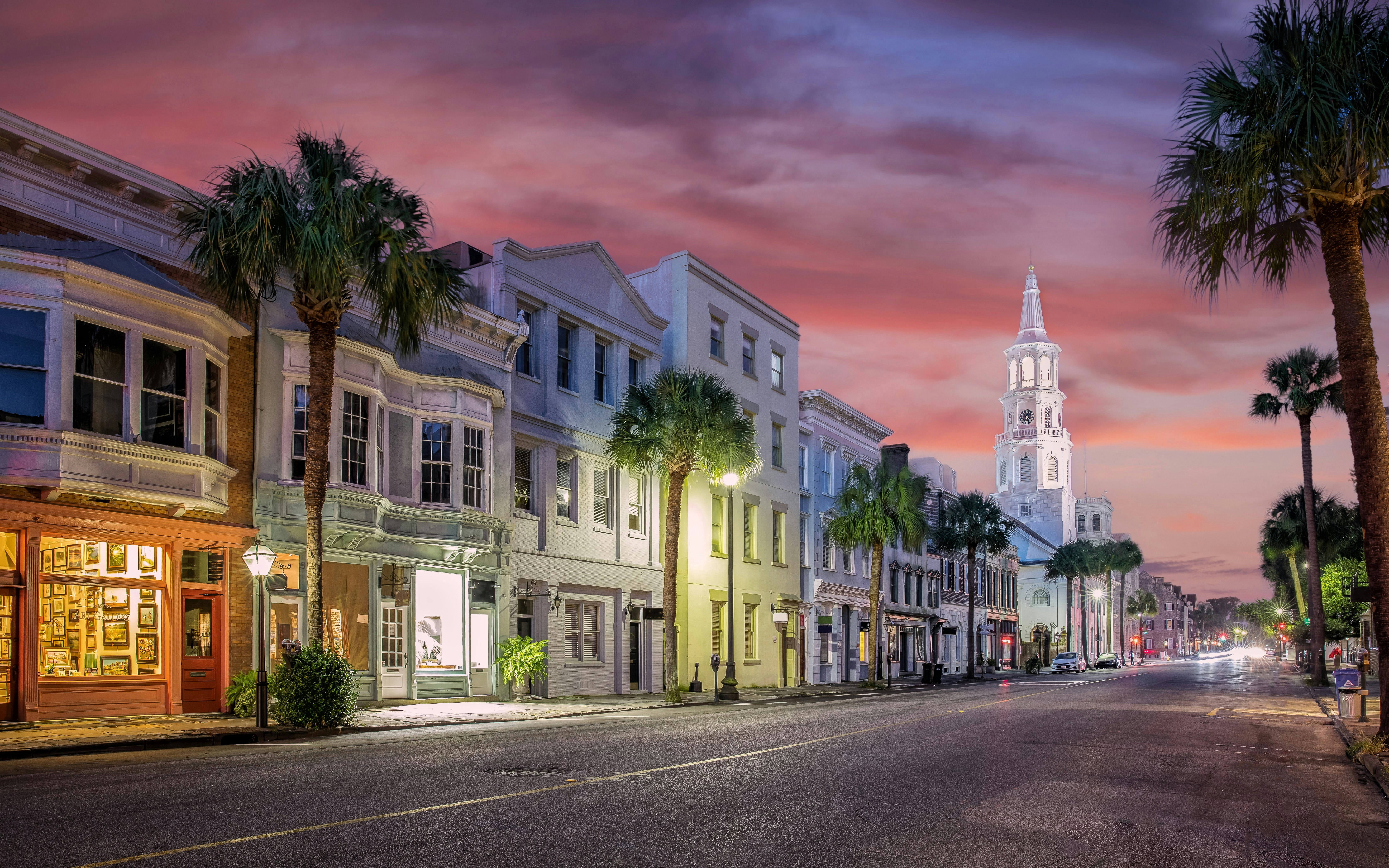 Downtown Charleston South Carolina street with historic buildings and sunset sky.